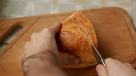 Man Slices Bread With Dull Knife Stock Footage 34185286