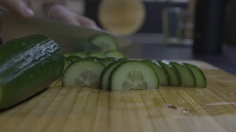 Man slices cucumbers into slices Stock Footage 101662931