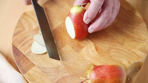 Man slices Forelle pear Stock Footage 76745748