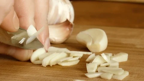 Man slices garlic Stock Footage 78304763
