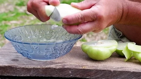 A man slices a green vegetable. Video stock 122910952