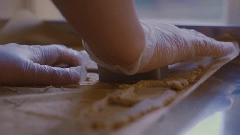 A man slices a rectangular cookie in the dough. Close-up side view Stock Footage 125956863
