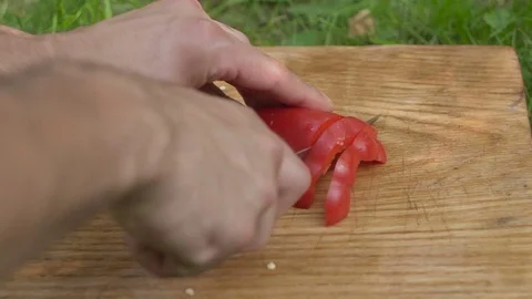 Man slices red pepper with a knife slow 스톡 동영상 80237593