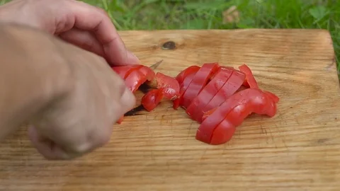 Man slices red pepper with a knife close up 스톡 동영상 80237844