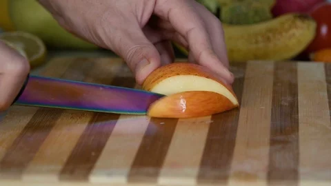 Man is slicing apple on cutting board Stock Footage 98201746