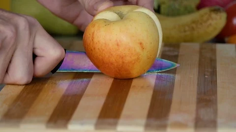 Man is slicing apple on cutting board Stock Footage 98201826
