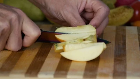 Man is slicing apple in slow motion Stock Footage 98201810