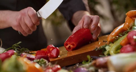 Man slicing  bell pepper on cutting board Stock Footage 311833060