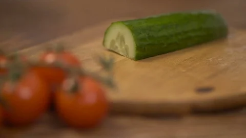 Man slicing up cucumber. Cook preparing vegetables. Video stock 71375748