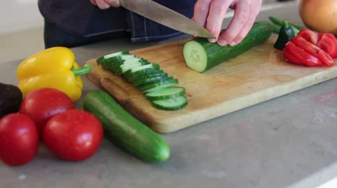 Man slicing up cucumber Stock Footage 41010850