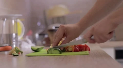 A man is slicing cucumber on the kitchen Stock Footage 54218543