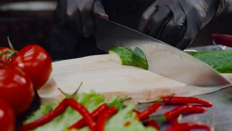 Man slicing cucumber with knife making healthy vegetables salad homemade cooking Stock Footage 153889775