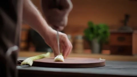Man slicing a fresh celery stalk lengthwise Stock Footage 312794794