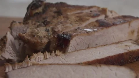 The man is slicing fried meat 動画素材 135828540