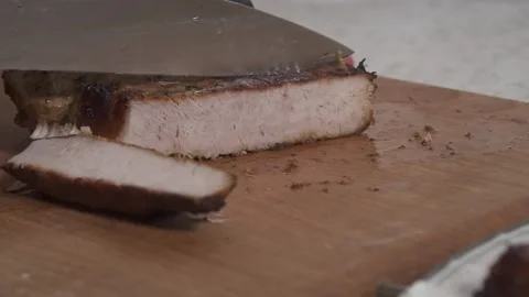 The man is slicing fried meat 動画素材 135828550