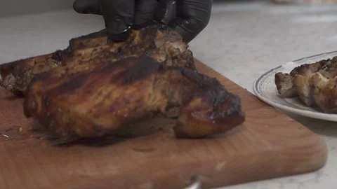 The man is slicing fried meat 動画素材 135828561