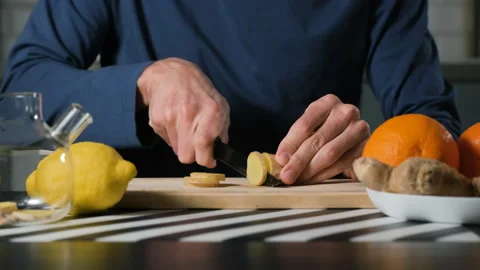 Man slicing ginger root on cutting board Stock-Footage 321953309