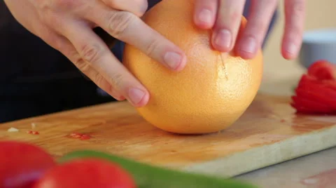 Man slicing grapefruit Stock Footage 40988479