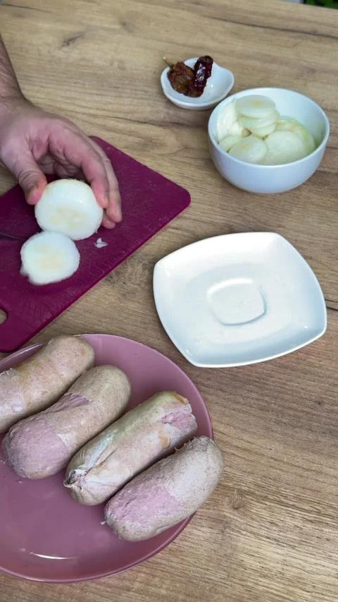 Man slicing onions into rings. For making pickled sausages. Vertical video. Stock Footage 328654564