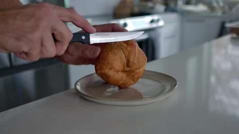 Man Slicing Pastry Bread In Half Using A Knife. - closeup shot 스톡 동영상 300992530