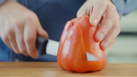Man Slicing Red Bell Pepper On Cutting Board In Kitchen Stock Footage 86068845