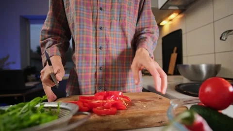 Man slicing red bell pepper timelapse close up lifestyle cooking healthy salad Stock Footage 316830877