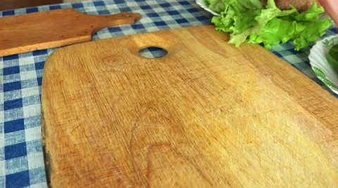 Man Slicing Red Tomato on a Kitchen Table Stock Footage 49912976