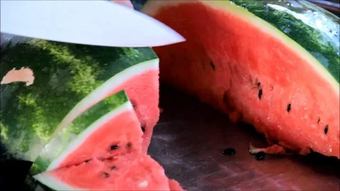 Man slicing a red watermelon Stock Footage 77862246