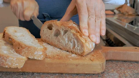 Man slicing slices of bread Stock Footage 100572982