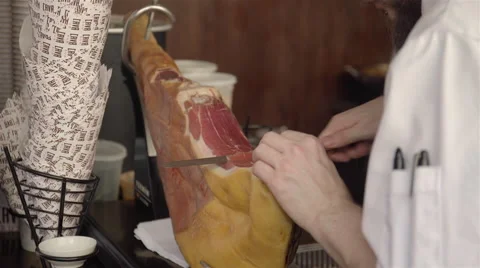 A man slicing some Jamon iberico at the market. Video stock 52367481