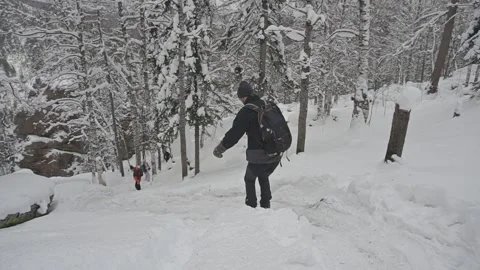 A man slides down a steep mountain slope in the snow, Russia Video stock 170456128