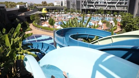 Man sliding down fun water slide at sunny day Stock Footage 101262629