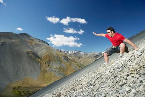 Man Sliding Down Scree Field Stock Photos