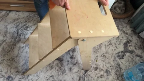 Man sliding small step ladder across floor at home, moving furniture, searching Stock Footage 337109044