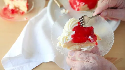 Man with slight tremor eats cake Stock Footage 65796464