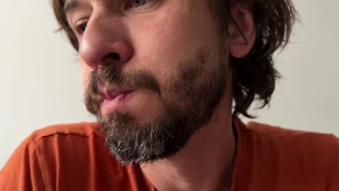 A man slightly puffs air inside his mouth, Stock Footage 335694446