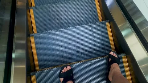 Man in slippers walking down escalator POV, walking down escalator steps Stock Footage 312403830