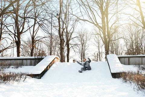Man slipping and falling down icy stairs in a winter park. Dangerous slippe.. Stock Photos