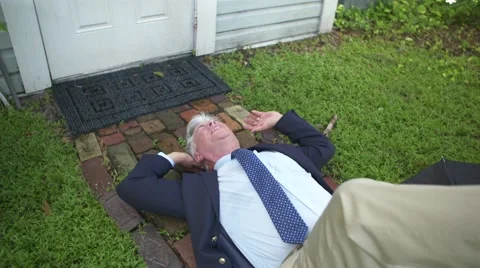 Man slips on wet sidewalk (slow-mo) Stock Footage 69067511