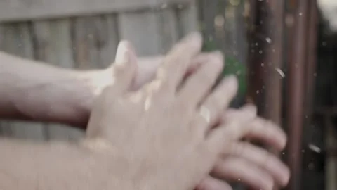 Man in slow motion dusts his hands of sawdust end of the work Stock Footage 145809537