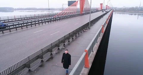 Man in slow motion walking over the bridge in deep fog. 動画素材 84047539