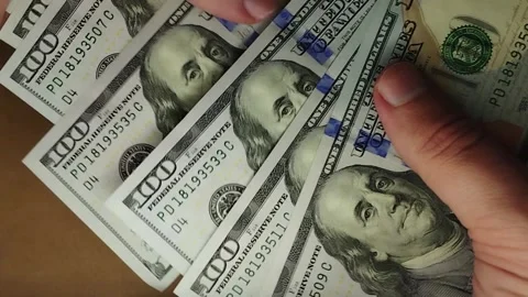 A man slowly counts US dollars. Stock Footage 241744906