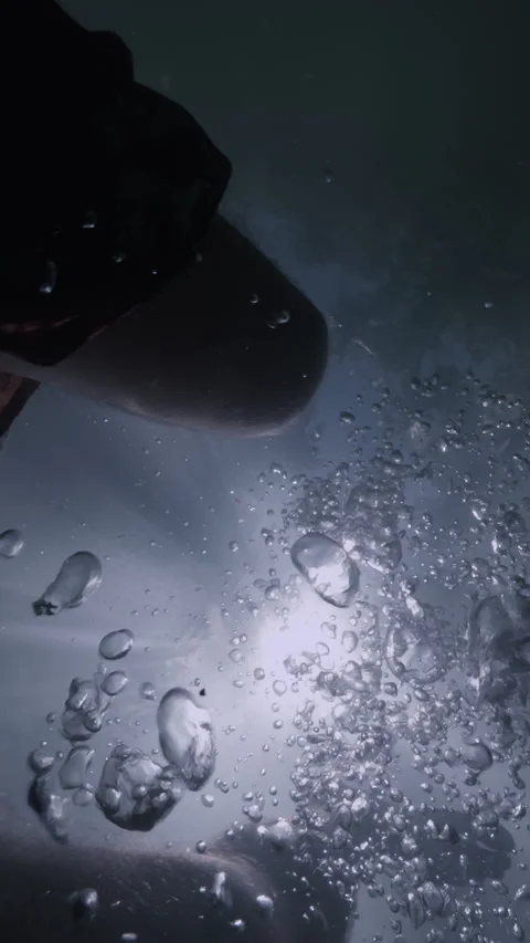  man slowly kicking his arms and legs under the surface of a large body of water Stock-Footage 283647953