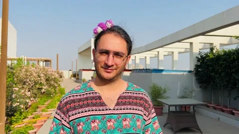 Man with small flowers on his head Stock Footage 234052171