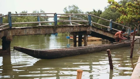 Man on small old boat on river, Indonesia Video stock 89662689
