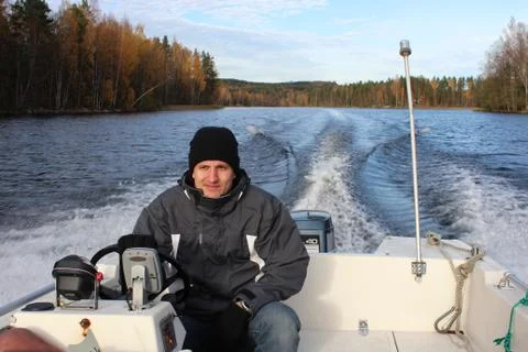 Man in a small power boat Stock Photos