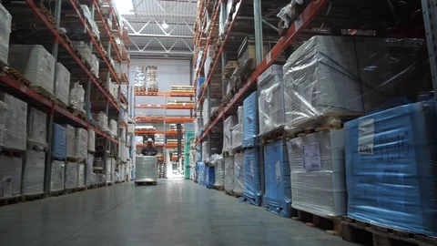 A man on a small square carries a pallet with the goods. Put the goods in place Stock-Footage 111766969
