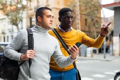 Man with smartphone asking for directions Stock Photos