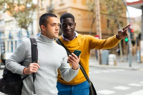 Man with smartphone asking for directions Stock Photos