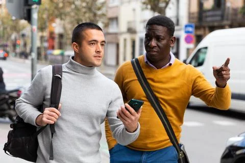 Man with smartphone asking for directions Stock Photos